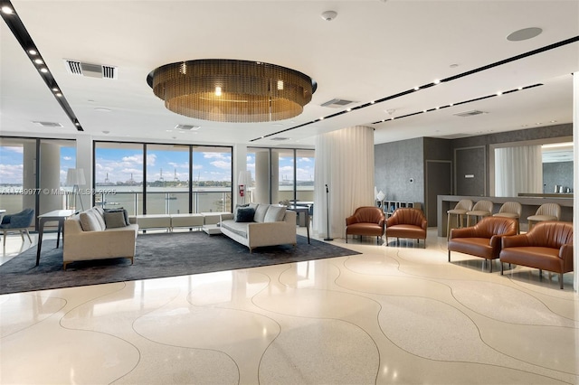 community lobby with floor to ceiling windows and a water view