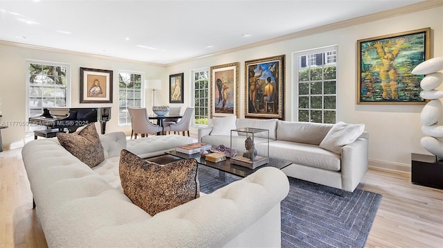 living room with crown molding, baseboards, wood finished floors, and a wealth of natural light