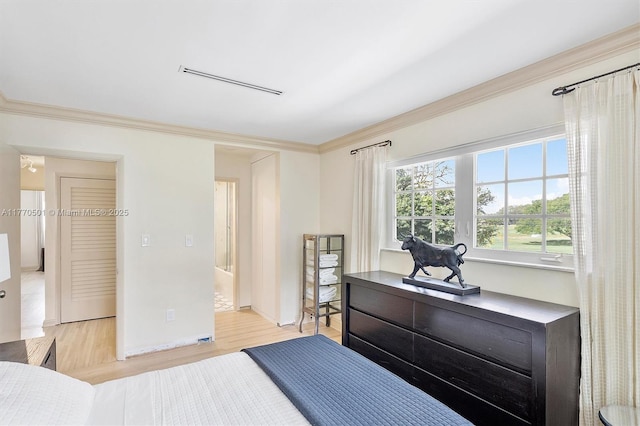bedroom with crown molding, baseboards, visible vents, and light wood-style floors