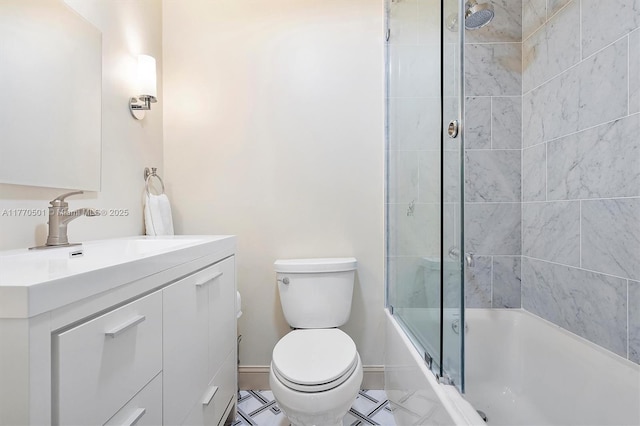 bathroom featuring baseboards, bath / shower combo with glass door, vanity, and toilet