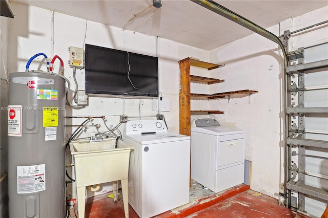 washroom featuring laundry area, washer / dryer, a sink, and water heater