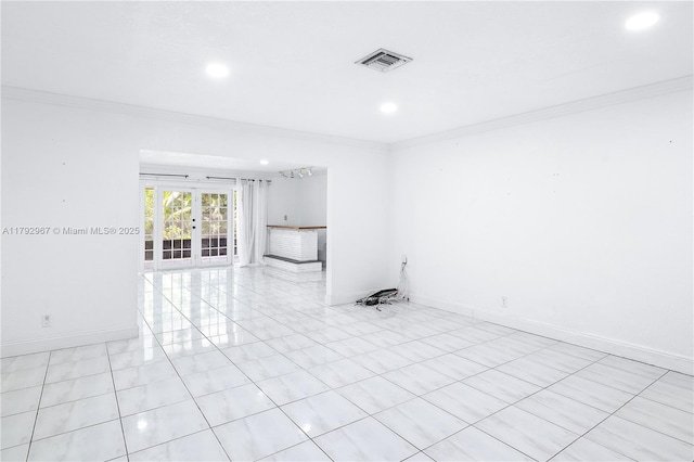 spare room featuring crown molding, light tile patterned flooring, baseboards, recessed lighting, and french doors