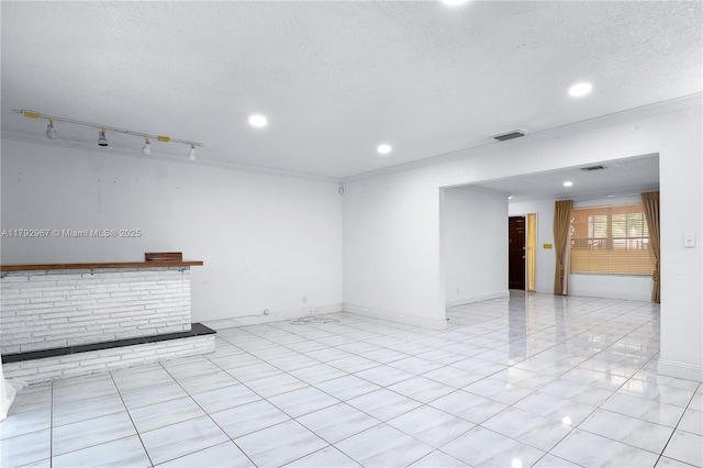 unfurnished room with crown molding, visible vents, baseboards, recessed lighting, and a textured ceiling