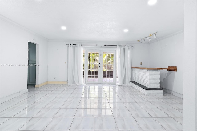 spare room with french doors, ornamental molding, baseboards, and recessed lighting