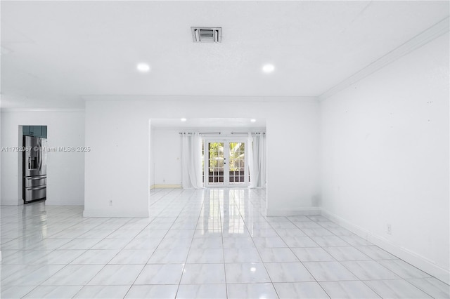 spare room with visible vents, recessed lighting, crown molding, and french doors
