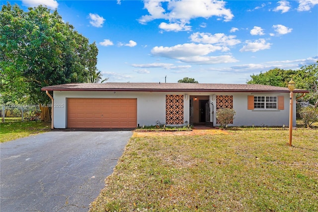 single story home with a front yard, a garage, fence, aphalt driveway, and stucco siding
