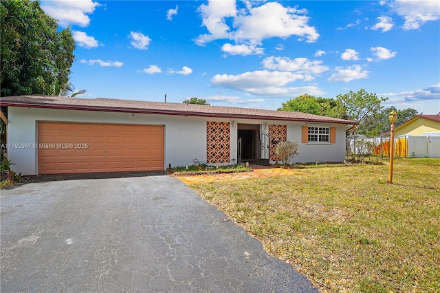 ranch-style house with a garage, driveway, a front yard, and stucco siding