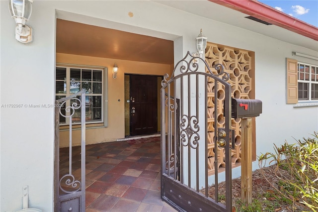 view of exterior entry with stucco siding