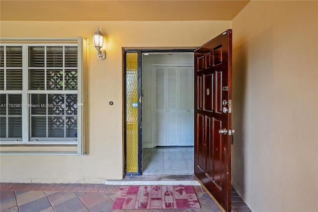 property entrance with stucco siding