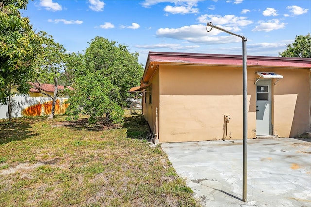 view of home's exterior featuring stucco siding, a patio area, and fence