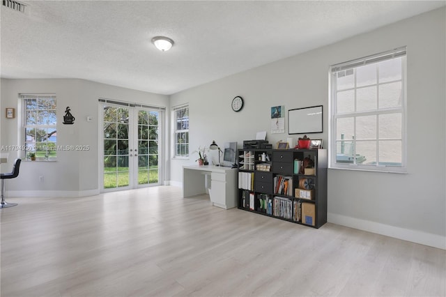 office area with visible vents, wood finished floors, baseboards, a textured ceiling, and french doors