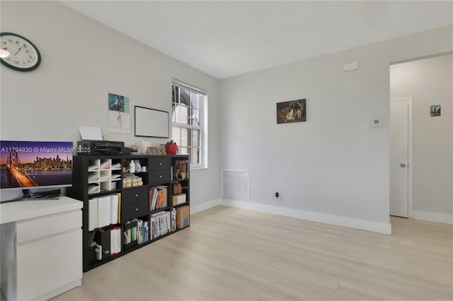 office area featuring baseboards and light wood finished floors