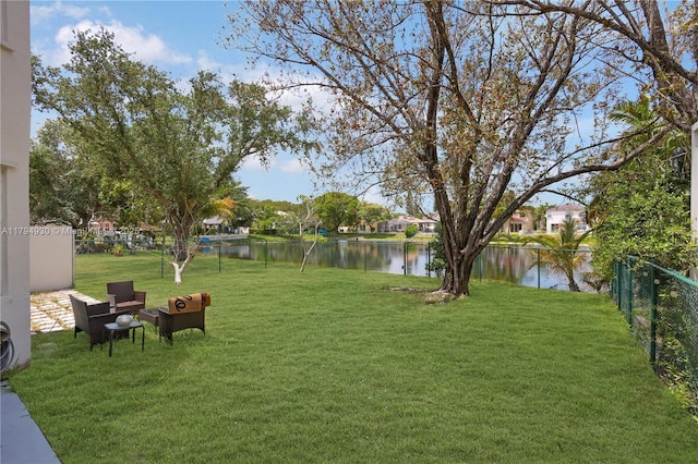 view of yard featuring fence and a water view