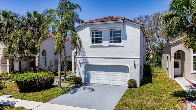mediterranean / spanish-style home featuring fence, stucco siding, a tiled roof, an attached garage, and driveway