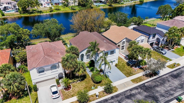 drone / aerial view featuring a water view and a residential view