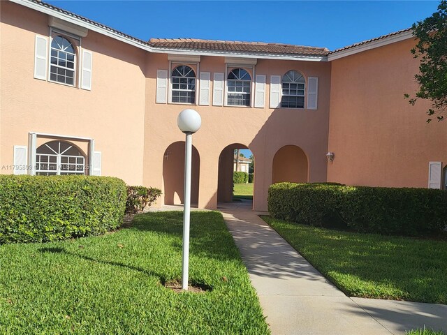 575 Augusta Blvd Unit 8, Naples, FL 34113 - mediterranean / spanish home with stucco siding, a tile roof, and a front yard