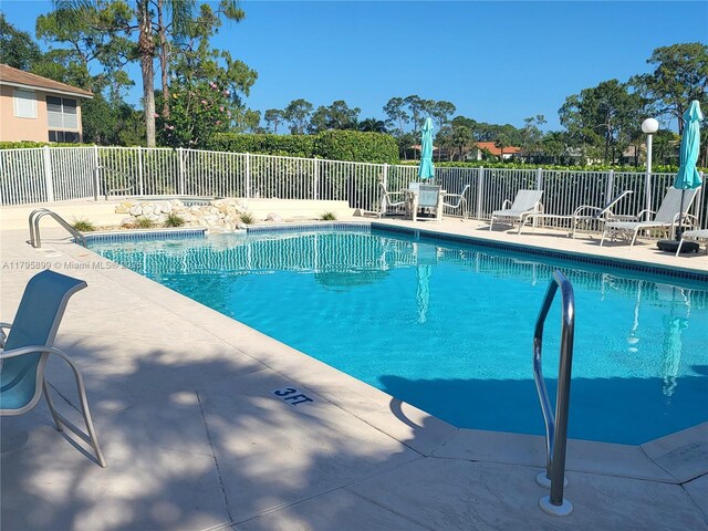 575 Augusta Blvd Unit 8, Naples, FL 34113 - community pool featuring a patio area and fence