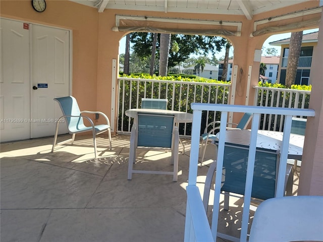 575 Augusta Blvd Unit 8, Naples, FL 34113 - sunroom featuring beam ceiling and a healthy amount of sunlight