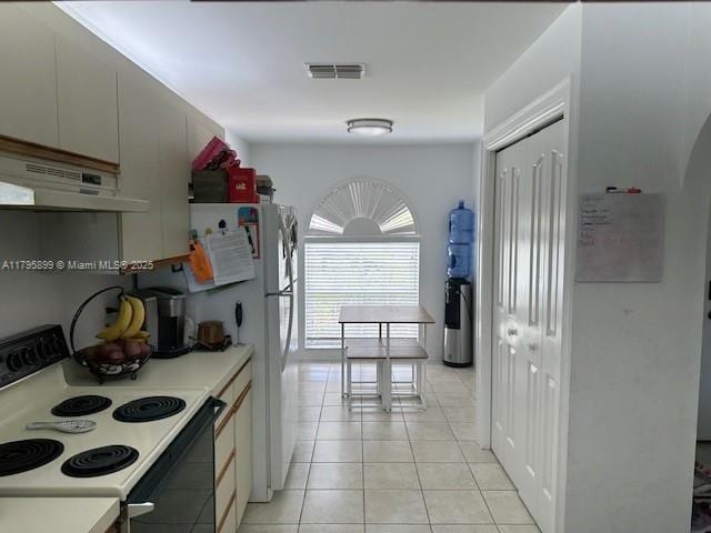 575 Augusta Blvd Unit 8, Naples, FL 34113 - kitchen featuring visible vents, light countertops, under cabinet range hood, light tile patterned floors, and range with electric cooktop