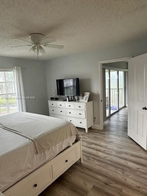 575 Augusta Blvd Unit 8, Naples, FL 34113 - bedroom with baseboards, a ceiling fan, a textured ceiling, and wood finished floors