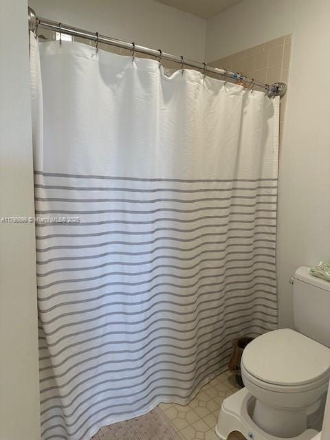 575 Augusta Blvd Unit 8, Naples, FL 34113 - bathroom with toilet and curtained shower