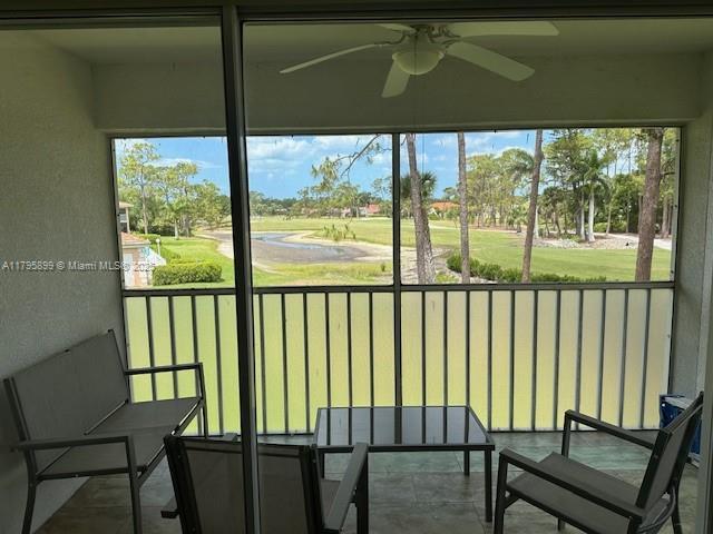 575 Augusta Blvd Unit 8, Naples, FL 34113 - sunroom / solarium featuring view of golf course and ceiling fan