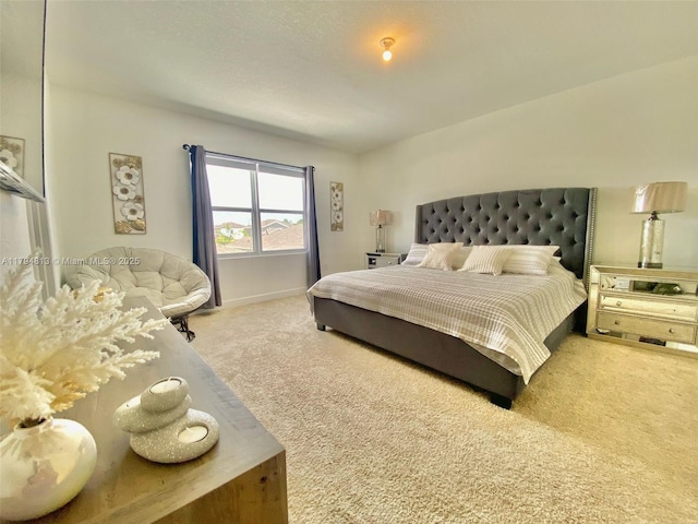 carpeted bedroom featuring baseboards