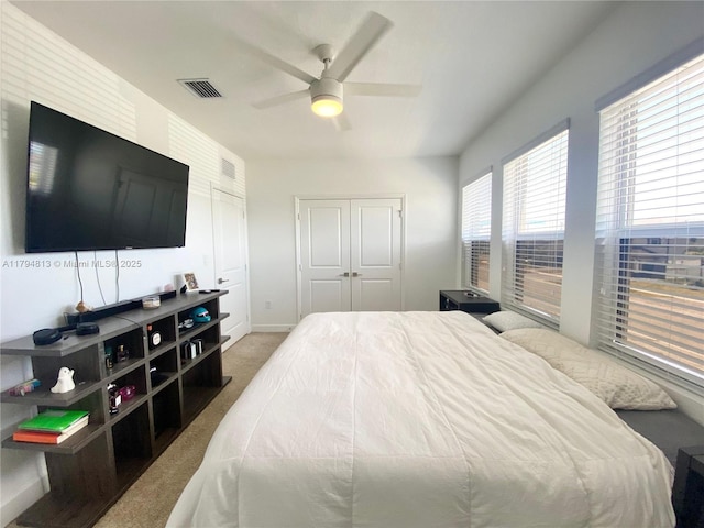 bedroom with carpet floors, ceiling fan, baseboards, and visible vents