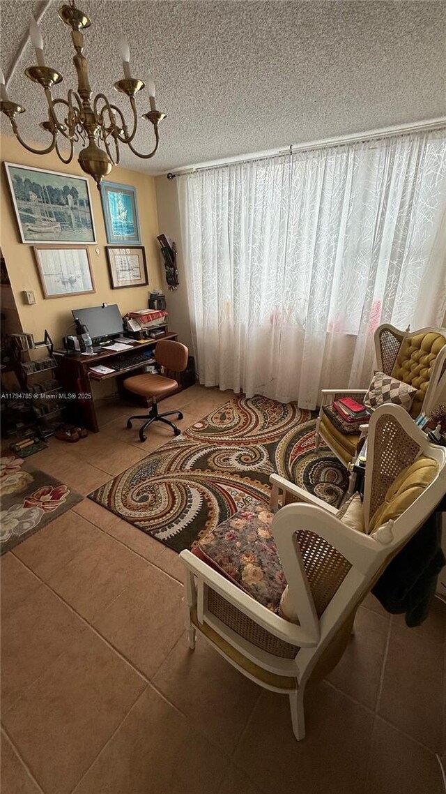 4330 Hillcrest Dr Unit 214, Hollywood, FL 33021 - living area with plenty of natural light, tile patterned floors, an office area, a chandelier, and a textured ceiling