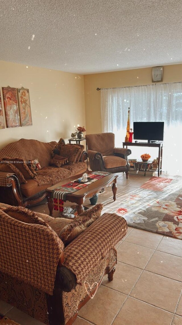 4330 Hillcrest Dr Unit 214, Hollywood, FL 33021 - living area with tile patterned flooring, plenty of natural light, and a textured ceiling