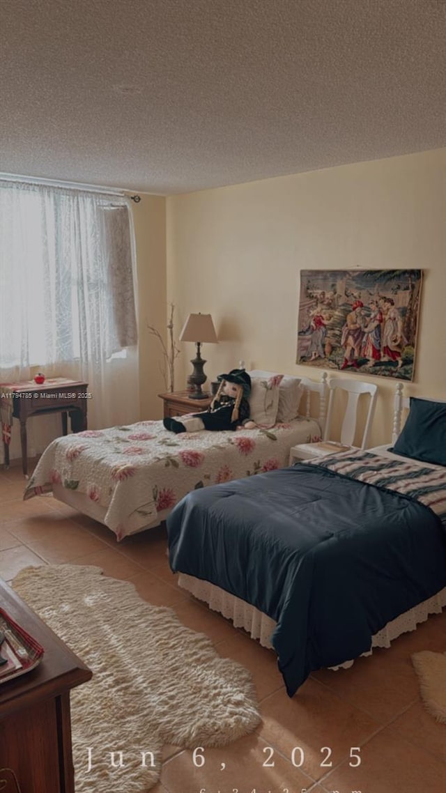 4330 Hillcrest Dr Unit 214, Hollywood, FL 33021 - bedroom featuring tile patterned flooring and a textured ceiling