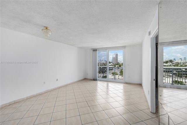 345 Ocean Dr Unit 904, Miami Beach, FL 33139 - unfurnished room featuring a textured ceiling, a view of city, and light tile patterned floors