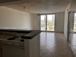 345 Ocean Dr Unit 904, Miami Beach, FL 33139 - empty room with healthy amount of natural light and tile patterned floors