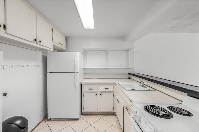 345 Ocean Dr Unit 904, Miami Beach, FL 33139 - kitchen with white appliances, light countertops, and light tile patterned flooring