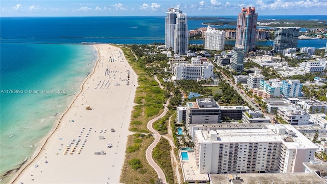 birds eye view of property with a water view, a city view, and a view of the beach