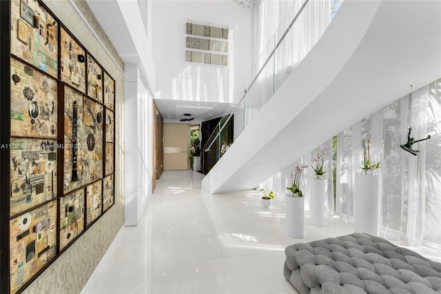 interior space featuring tile patterned flooring and a towering ceiling