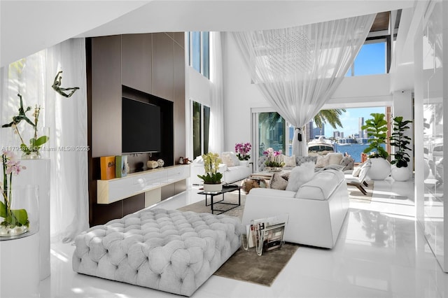 tiled living area featuring a towering ceiling