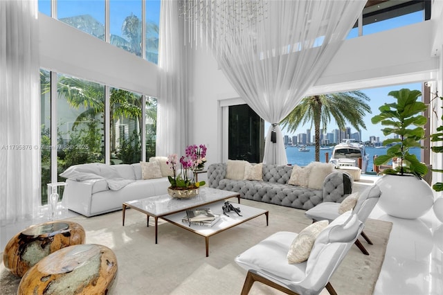 living room with a towering ceiling and a city view