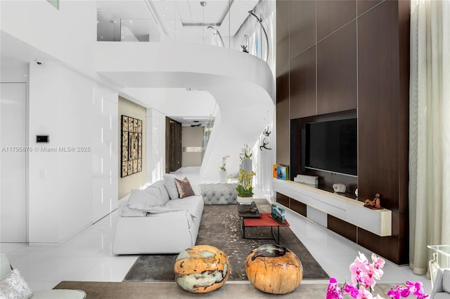 tiled living area featuring a towering ceiling
