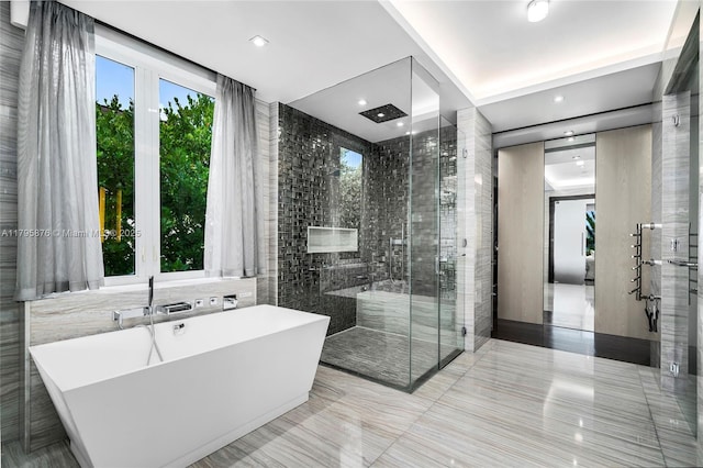 bathroom featuring a freestanding bath and a stall shower