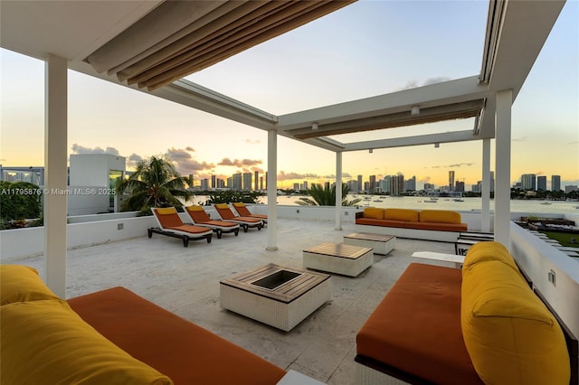 patio terrace at dusk with a city view and an outdoor living space