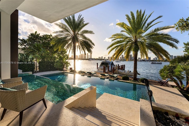 outdoor pool featuring a water view and a jacuzzi