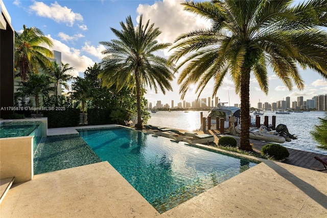 pool featuring a city view, boat lift, a water view, and a boat dock