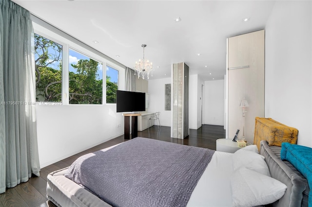 bedroom with dark wood-style flooring and a notable chandelier