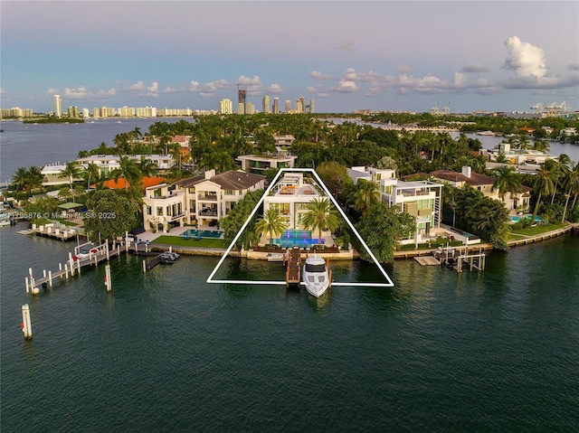 birds eye view of property featuring a city view and a water view