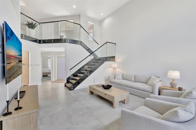 6393 Brava Way, Boca Raton, FL 33433 - living room featuring concrete flooring, a high ceiling, stairs, and recessed lighting
