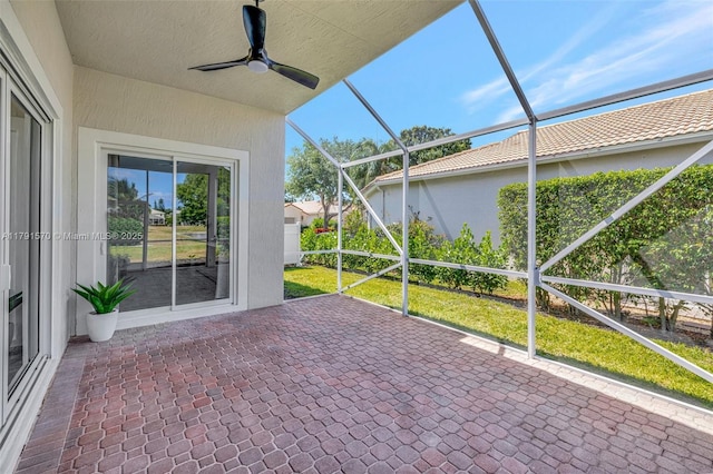 unfurnished sunroom featuring ceiling fan