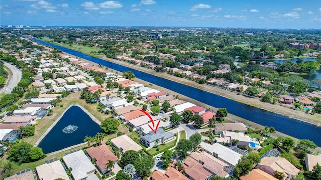 drone / aerial view featuring a water view and a residential view