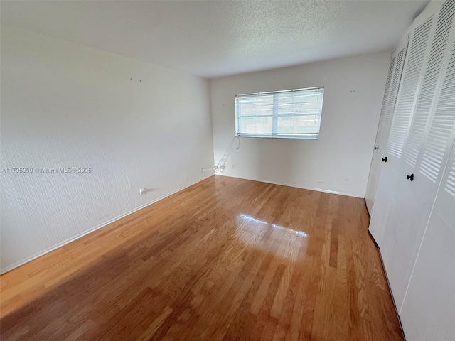 2935 W Crosley Dr Unit B, West Palm Beach, FL 33415 - unfurnished bedroom with wood finished floors, a closet, and baseboards