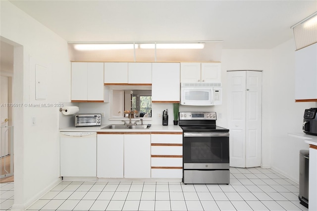kitchen with light countertops, white cabinetry, a toaster, and white appliances